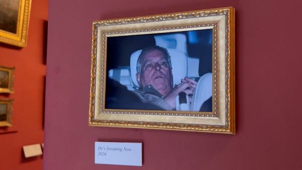 activists-hang-andrew-arrest-photo-at-louvre-museum-1771863606.jpg